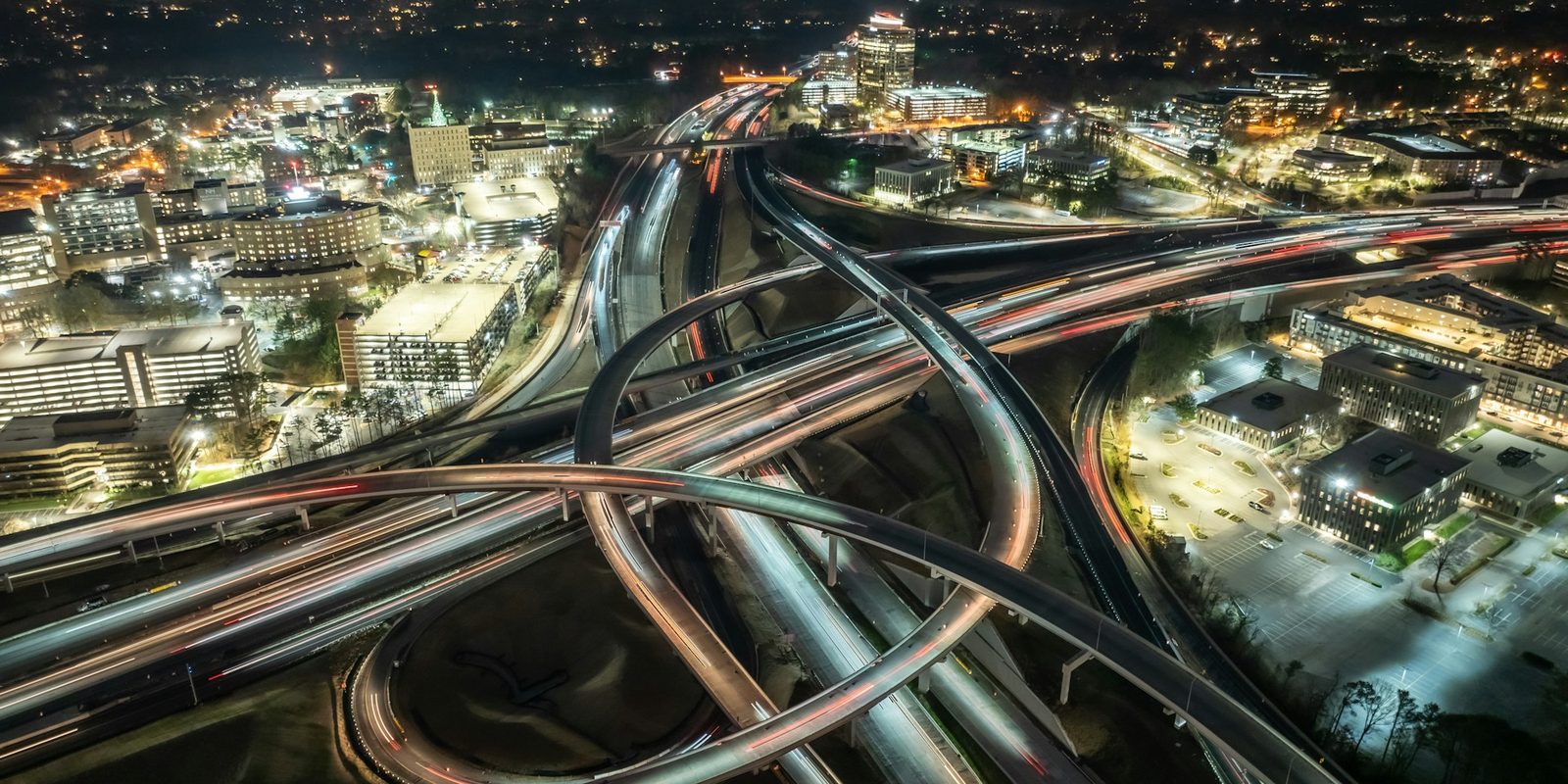 A highway interchange from above at night.